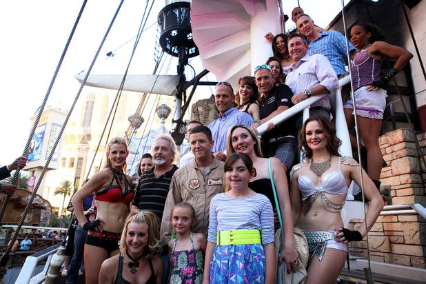 U.S. Air Force Capt. John Costa, center in uniform, poses for a photo with his family after surprising his daughters by appearing at the end of the "Sirens of TI" show at Treasure Island in Las Vegas on Tuesday, June 4, 2013. Costa was deployed for a year-long tour in Afghanistan.