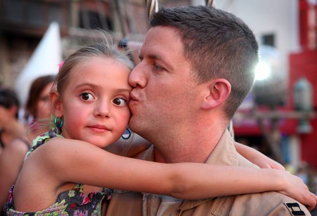 U.S. Air Force Capt. John Costa surprised his daughter Tally, 6, by appearing at the end of the "Sirens of TI" show at Treasure Island in Las Vegas on Tuesday, June 4, 2013. Costa was deployed for a year-long tour in Afghanistan.