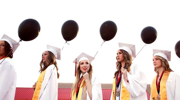 Las Vegas High School valedictorian Natasha Greene, center,  attends her commencement ceremony on the school's football field in Las Vegas on Friday, June 7, 2013. Greene has had perfect attendance and perfect grades since kindergarten.