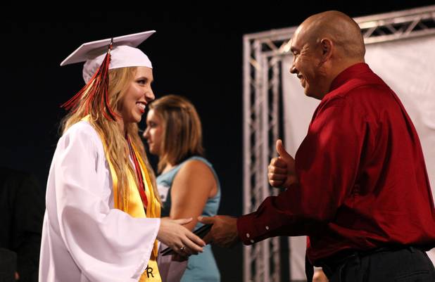 Las Vegas High School valedictorian Natasha Greene accepts her diploma during her commencement ceremony on the school's football field in Las Vegas on Friday, June 7, 2013. Greene has had perfect attendance and perfect grades since kindergarten.