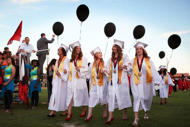Las Vegas High School valedictorian Natasha Greene, center, walks with fellow valedictorians during her commencement ceremony on the school's football field in Las Vegas on Friday, June 7, 2013. Greene has had perfect attendance and perfect grades since kindergarten.