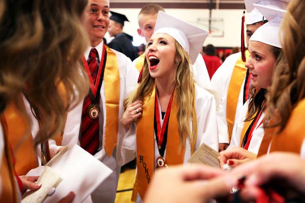 Las Vegas High School valedictorian Natasha Greene talks with friends before her commencement ceremony on the school's football field in Las Vegas on Friday, June 7, 2013. Greene has had perfect attendance and perfect grades since kindergarten.