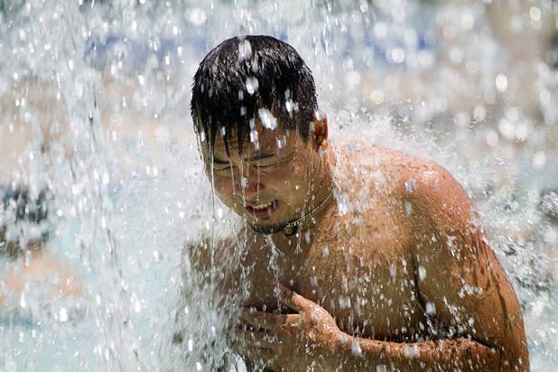 James Ikeda keeps cool in the Henderson Multigenerational Activity Pool Sunday, June 9, 2013. Sunday's high temperature was 109, two degrees shy of the record.