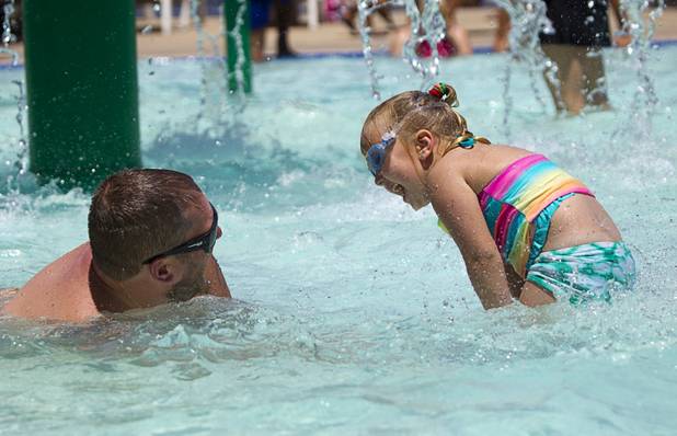 Matthew DeBerry plays with his daughter Bailey, 3, at the Henderson Multigenerational Activity Pool Sunday, June 9, 2013. Sunday's high temperature was 109, two degrees shy of the record.