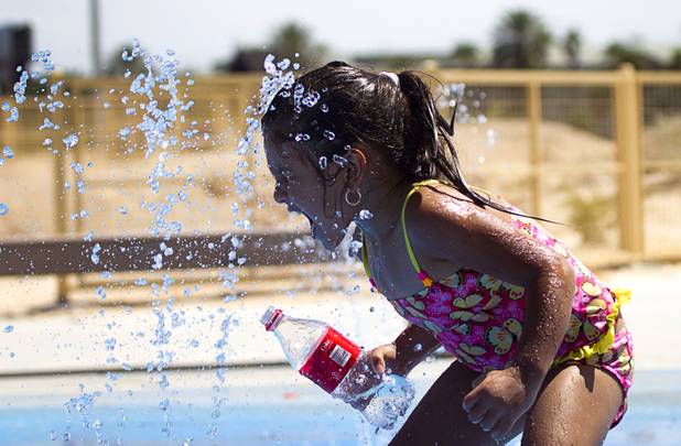 Emily Garcia, 5, plays at Charlie Frias Park Sunday, June 9, 2013. Sunday's high temperature was 109, two degrees shy of the record.