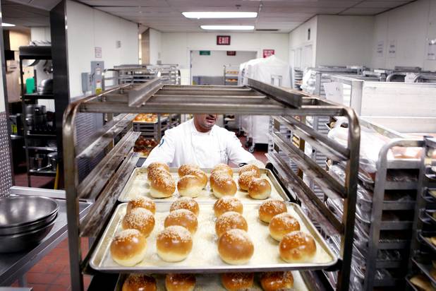 Pastry chef Antonio Vera rolls a rack of fresh bread inside the basement bakery at Caesars Palace in Las Vegas on Tuesday, June 11, 2013.