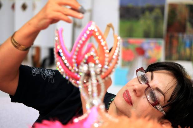 Wardrobe technician Shahnaz Minaian repairs a headpiece inside the Jubilee! costume shop at Bally's in Las Vegas on Tuesday, June 11, 2013.