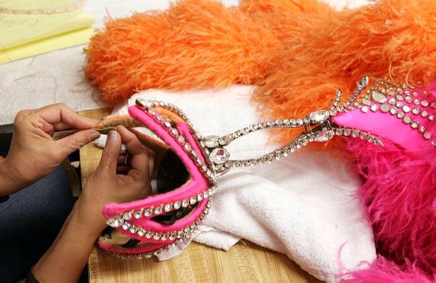 Wardrobe technician Shahnaz Minaian repairs a headpiece inside the Jubilee! costume shop at Bally's in Las Vegas on Tuesday, June 11, 2013.
