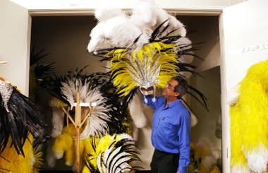 Marios Ignadiou, head of the costume shop at “Jubilee!”  at Bally’s, holds up a headpiece from the disco number Tuesday, June 11, 2013, at the long-running show.