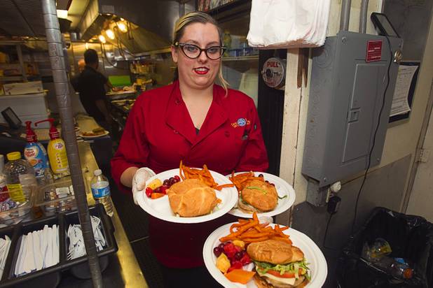 Circus train food and beverage manager Colleen Doyle serves lunch on the "Pie Car," the dining car on the Ringling Bros. and Barnum & Bailey Circus train, Wednesday, June 12, 2013. Circus performers teamed up with the Three Square Food Bank to pack 100 food backpacks for local families and hosted Three Square families with a lunch on the Pie Car. The circus opens Thursday at the Thomas & Mack Center and runs through Sunday.