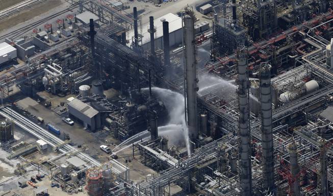 A chemical plant fire is seen in this aerial photo about twenty miles southeast of Baton Rouge, in Geismer, La., Thursday, June 13, 2013.  Ambulances and helicopters took at least 30 people from the burning chemical plant after an explosion Thursday, officials said. Early tests did not indicate dangerous levels of any chemicals around the plant, but area residents were told to remain indoors with doors and windows closed, said Jean Kelly, spokeswoman for the state Department of Environmental Quality.