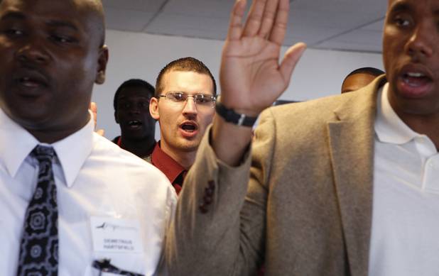 Graduate Thomas McEniry, center, takes an oath with other graduates during the Hope for Prisoners graduation ceremony in Las Vegas on Friday, June 14, 2013. Hope for Prisoners provides intensive one week training for prisoners reentering society.
