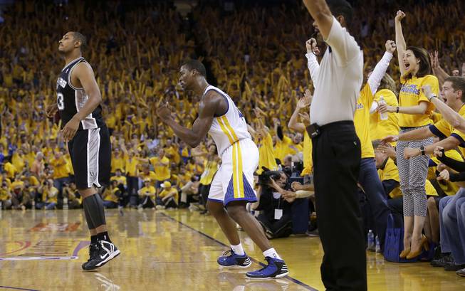 Golden State Warriors forward Harrison Barnes, center, celebrates next to San Antonio Spurs center Boris Diaw after scoring during the third quarter of Game 4 of a Western Conference semifinal NBA basketball playoff series in Oakland, Calif., Sunday, May 12, 2013. The Warriors won 97-87 in overtime. Barnes had 26 points and 10 rebounds. 