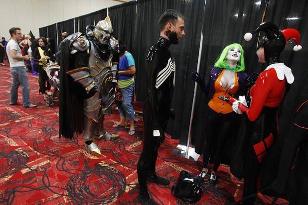 Chris Thompson as Spiderman, Twiggy Tallent as a female Joker and creator of the vinyl costumes Melanie Thompson wait in line for judging during the costume contest at the Amazing Las Vegas Comic Con at the South Point Saturday, June 15, 2013.