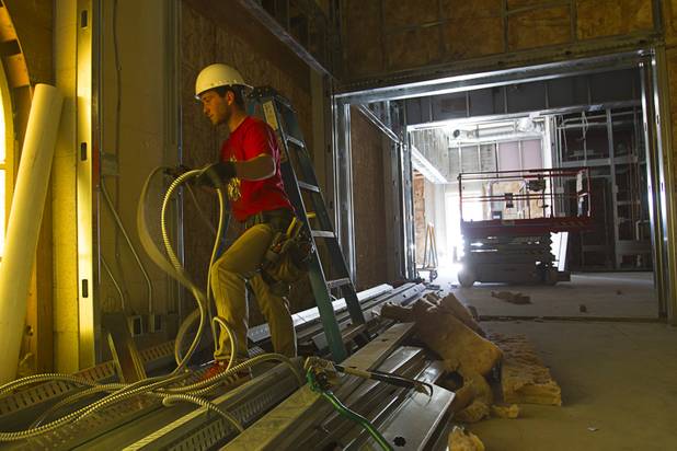 Dylan Crenshaw, an electrician with Amazon Electric, works at the 9th Bridge School at 9th Street and Bridger Avenue in downtown Las Vegas Monday, June 17, 2013. The private school/early childhood learning center, part of the DowntownProject, is scheduled to open August 26 with infants through kindergarten students and gradually add grades.