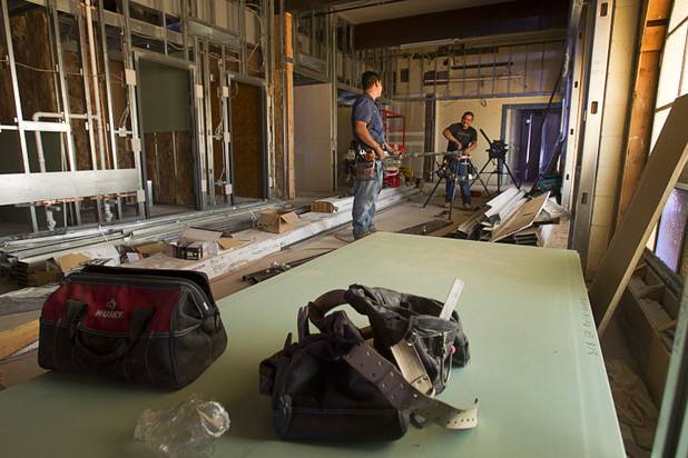 Benjamin Morales, left, and Heladio Barrera work on a sprinkler system at the 9th Bridge School at 9th Street and Bridger Avenue in downtown Las Vegas Monday, June 17, 2013. The private school/early childhood learning center, part of the DowntownProject, is scheduled to open August 26 with infants through kindergarten students and gradually add grades.