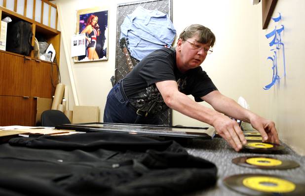 Display technician Susan Riley puts together a Johnny Cash display on Monday, June 17, 2013 at the Hard Rock Hotel in Las Vegas.