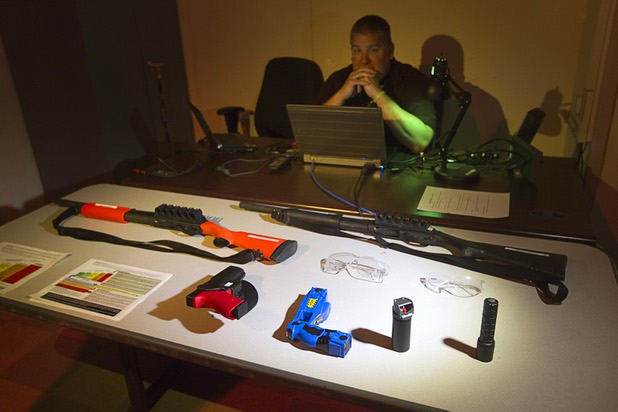 MILO room coordinator Mike Richards sits behind training weapons during a tour of the Metro Police training facility Wednesday, June 19, 2013. MILO (Multiple Interactive Learning Objectives) is a interactive training system for cadets and officers. With the recent passage of the "More Cops" bill, Metro Police announced they will soon hold the first police academy since January 2012.