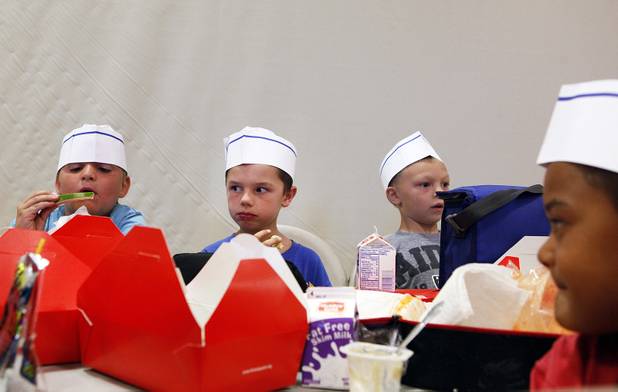 Gabriel Monroe, from left, 7, Ryan Hackworth, 6, and Gary Saastad, 6, eat lunch during the Summer Food Service Program at the Heinrich YMCA in Las Vegas on Wednesday, June 19, 2013. The Summer Food Service Program is a federal nutrition program designed to feed children free, nutritious meals and snacks during the months of June, July, and August when school is out.