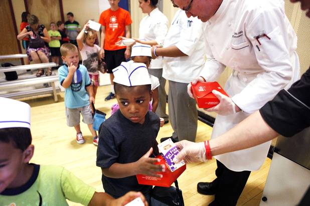 James Payne, 4, collects his lunch during the Summer Food Service Program at the Heinrich YMCA in Las Vegas on Wednesday, June 19, 2013. The Summer Food Service Program is a federal nutrition program designed to feed children free, nutritious meals and snacks during the months of June, July, and August when school is out.