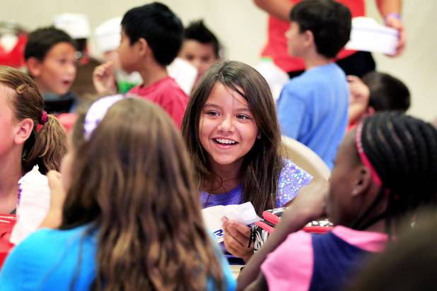 Emma Cole, 10, talks with friends during Summer Food Service Program lunch at the Heinrich YMCA in Las Vegas on Wednesday, June 19, 2013. The Summer Food Service Program is a federal nutrition program designed to feed children free, nutritious meals and snacks during the months of June, July, and August when school is out.