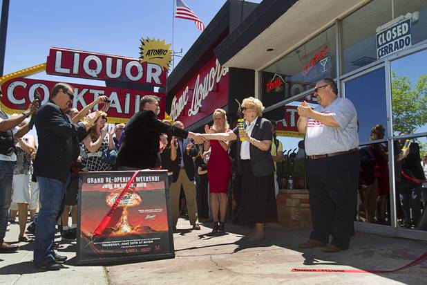 Las Vegas Mayor Carolyn Goodman shakes hands with Atomic co-owner Derek Stonebarger during the grand reopening of The Atomic on East Fremont Street Wednesday, June 20, 2013. The other owners are Lance Johns, left, and his brother Kent, right. The bar was was originally built in 1945 as Virginia's Cafe but was renamed Atomic Liquors in 1952 when patrons used to go to the roof to watch the nuclear blasts from the Atomic Test Site. The Atomic has been sold to Tony Hsieh’s Downtown Project.
