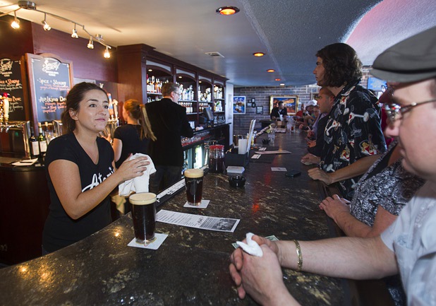 Bartender Ashlea Latham, left, serves drinks during the grand reopening of The Atomic on East Fremont Street Wednesday, June 20, 2013. The bar was originally built in 1945 as Virginia's Cafe but was renamed Atomic Liquors in 1952 when patrons used to go to the roof to watch the nuclear blasts from the Atomic Test Site.