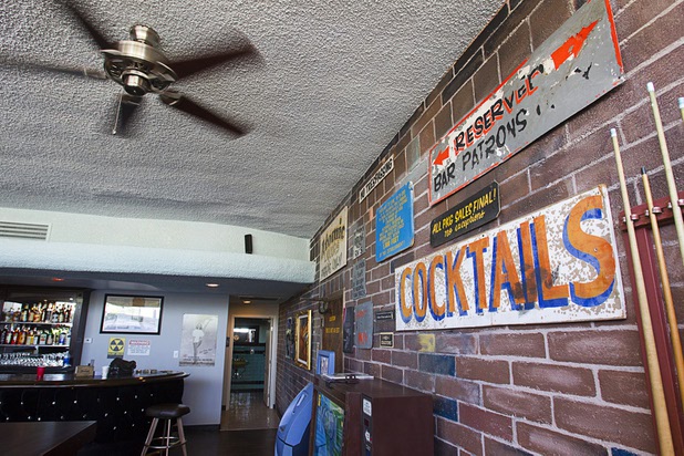 Signs by local artist Jon Peterson are displayed on a wall before the grand re-opening of The Atomic on East Fremont Street Wednesday, June 20, 2013. The bar was originally built in 1945 as Virginia's Cafe but was renamed Atomic Liquors in 1952 when patrons used to go to the roof to watch the nuclear blasts from the Atomic Test Site.