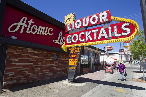 A pedestrian walks by The Atomic on East Fremont Street Wednesday, June 20, 2013. The bar was originally built in 1945 as Virginia's Cafe but was renamed Atomic Liquors in 1952 when patrons used to go to the roof to watch the nuclear blasts from the Atomic Test Site.