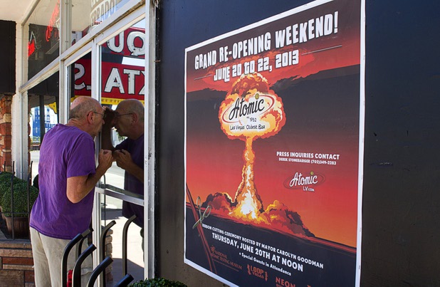 A passerby looks into The Atomic on East Fremont Street  before the bar's grand re-opening Wednesday, June 20, 2013.