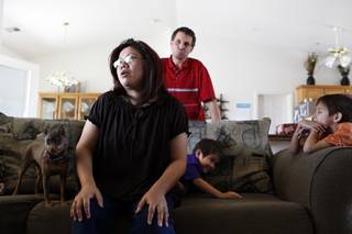 Tina Kitchel at home with her husband Jason and children Jonathan, far right, 6, and Christian, 3, on Thursday, June 20, 2013 in Pahrump. Kitchel went into cardiac arrest three years ago during the birth of her son Christian. Her heart stopped for 27 minutes and she was in a coma for 13 days. Today, her brain no longer has the function to store short term memory.