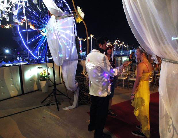 Brian Mills officiates as Shacura and Charles Mendoza exchange wedding vows during the first night of the Electric Daisy Carnival Friday, June 21, 2013 at the Las Vegas Motor Speedway.