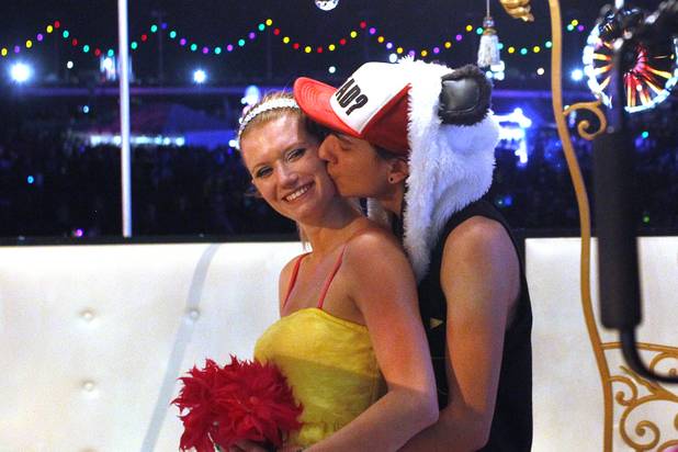 Charles Mendoza kisses his bride Shacura Mendoza after exchanging wedding vows during the first night of the Electric Daisy Carnival Friday, June 21, 2013 at the Las Vegas Motor Speedway.