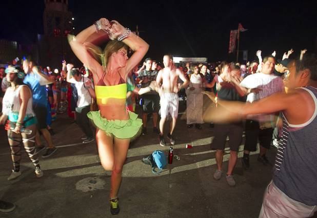 A carnival-goer dances to Indecent Noise during the third day of the Electric Daisy Carnival at the Las Vegas Motor Speedway Sunday, June 23, 2013.