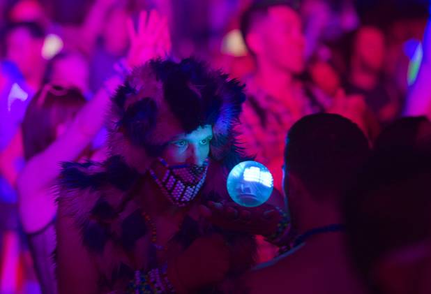 A festival-goer plays with an illuminated ball during the third day of the Electric Daisy Carnival at the Las Vegas Motor Speedway Sunday, June 23, 2013.