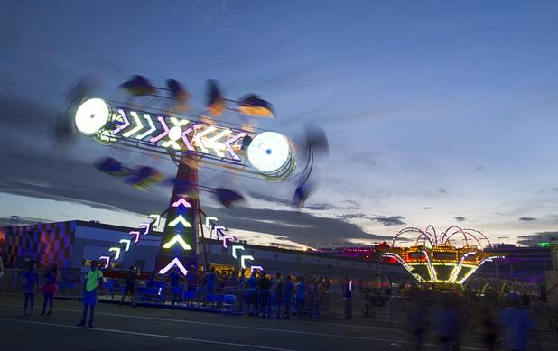 Carnival rides spin during the third day of the Electric Daisy Carnival at the Las Vegas Motor Speedway Sunday, June 23, 2013.