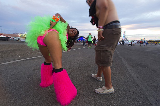 Andrea Avina of Chicago shows off her costume during the third day of the Electric Daisy Carnival at the Las Vegas Motor Speedway Sunday, June 23, 2013. Alfonso Bribiesca is at right.