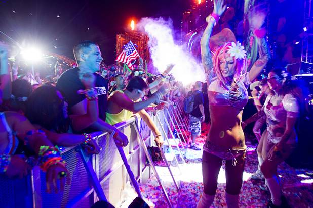 A performer dances by the audience during the third day of the Electric Daisy Carnival at the Las Vegas Motor Speedway early Monday morning, June 24, 2013.