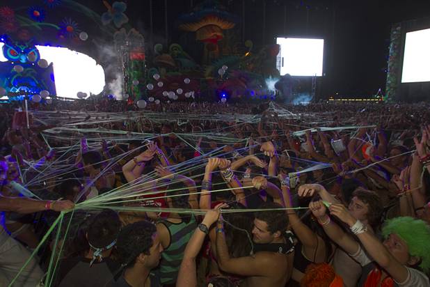 Festival-goers are covered with a "spiderweb" during the third day of the Electric Daisy Carnival at the Las Vegas Motor Speedway early Monday morning, June 24, 2013.