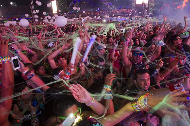 Festival-goers are covered with a "spiderweb" during the third day of the Electric Daisy Carnival at the Las Vegas Motor Speedway early Monday morning, June 24, 2013.