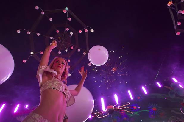 Fireworks explode behind a performer during the third day of the Electric Daisy Carnival at the Las Vegas Motor Speedway early Monday morning, June 24, 2013.