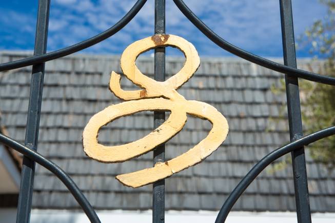 One of the few signature L's left on the front gate of Liberace's former home at 4982 Shirley St., Las Vegas, Monday, June 24, 2013.