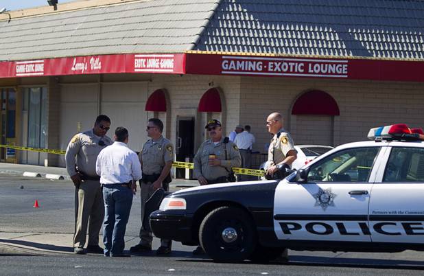Metro Police confer outside Larry's Villa, 2401 W. Bonanza Rd., after a shooting, Wednesday, June 26, 2013. 