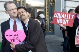 John Lewis, left, and Stuart Gaffney embrace outside San Francisco's City Hall shortly before the U.S. Supreme Court ruling cleared the way for same-sex marriage in California on Wednesday, June 26, 2013.  