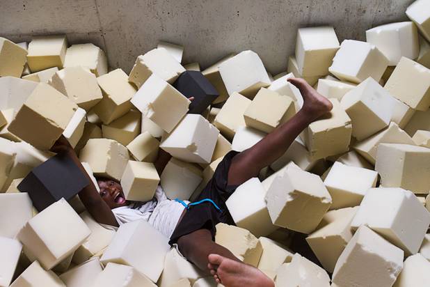 Keijon Braxton, 13, a member of the Victory Baptist Church STARS Youth Ministry, falls into a foam pit at the Hardkore Parkour (HKPK) gym, 3680 N. 5th St., Thursday, June 27, 2013.