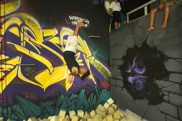 D.J. Matthews, 17, a member of the Victory Baptist Church STARS Youth Ministry, flips into a foam pit at the Hardkore Parkour (HKPK) gym, 3680 N. 5th St., Thursday, June 27, 2013.