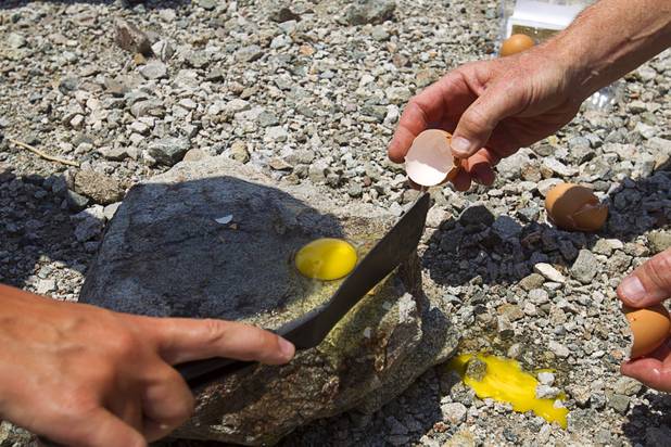 Bengt Jonsson of Sweden tries to fry an egg on a rock at Badwater Basin, 282 feet (85.5m) below sea level, in Death Valley National Park Saturday, June 29, 2013.