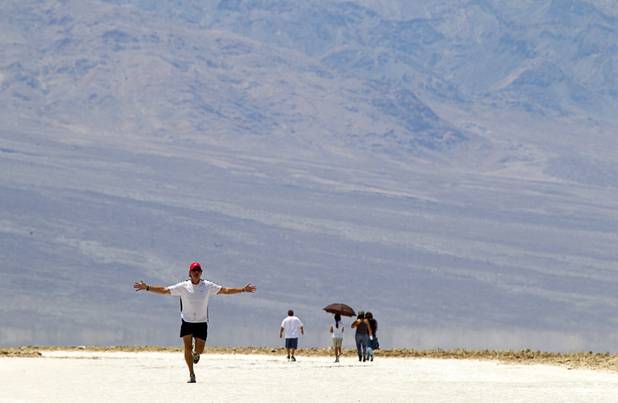 Marathon runner Fred Von Canon (L) of Sanford, North Carolina celebrates after a two mile run at Badwater Basin, 282 feet (85.5m) below sea level, in Death Valley National Park Saturday, June 29, 2013. Canon said he could resist the challenge and ran out into the salt flats for a mile before returning.