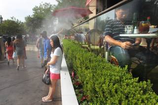 Passersby take advantage of the misters at the Candy Factory to cool off on the Strip Saturday, June 29, 2013.