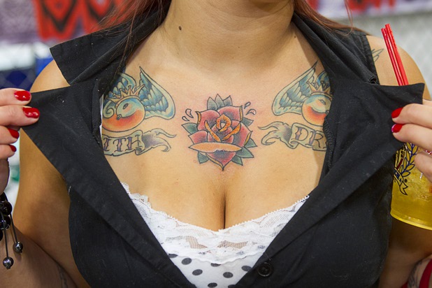Kristal Sanchez of Las Vegas shows off her rose tattoo at the Philthy Clean Tattoo booth during the inaugural Art N Ink Festival at the South Point Sunday, June 30, 2013.